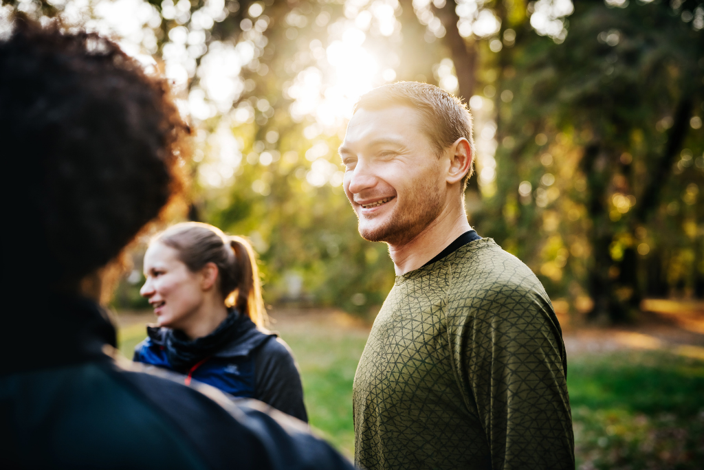 Man smiling while outside in natural setting